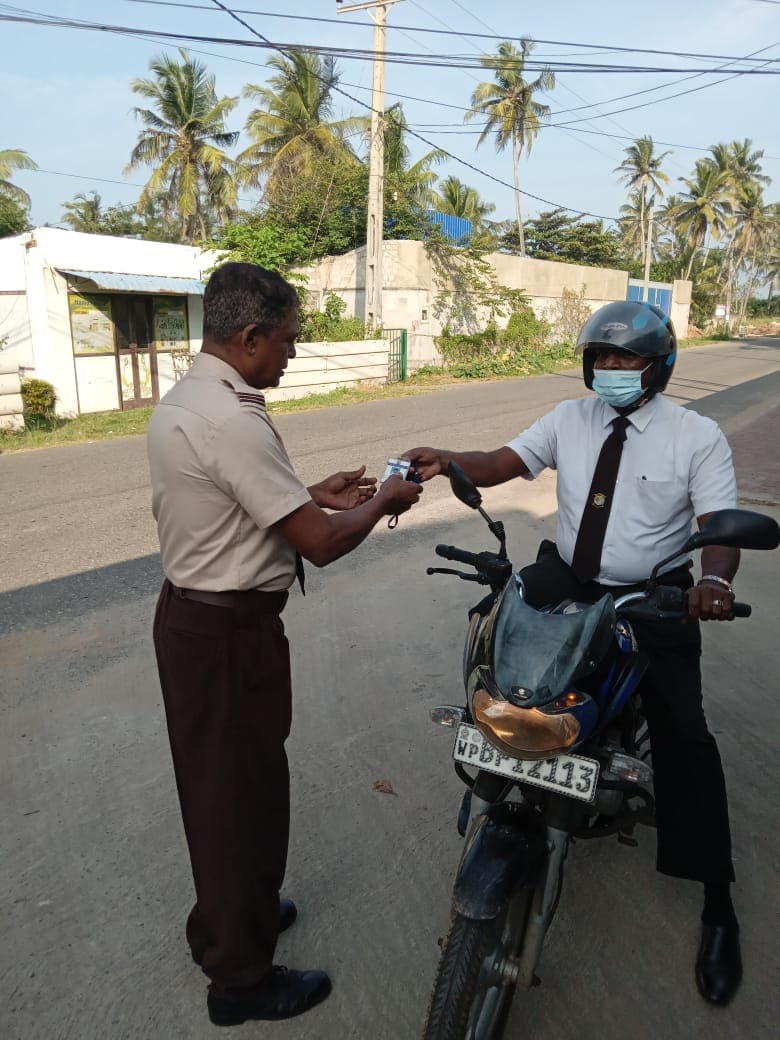 Security guard checking a rider at the roadside